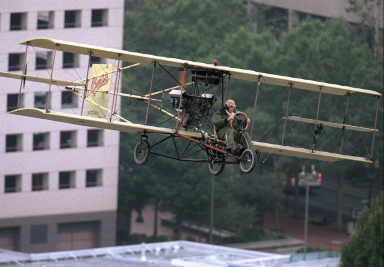 Aviator Tom Murphy pilots his Curtis Pusher biplane replica through downtown Portland on Sept. 16, 1995, after flying  off a ramp on top of the eight-story tall historic Multnomah Hotel in a re-enactment of a 1912 flight to Vancouver.