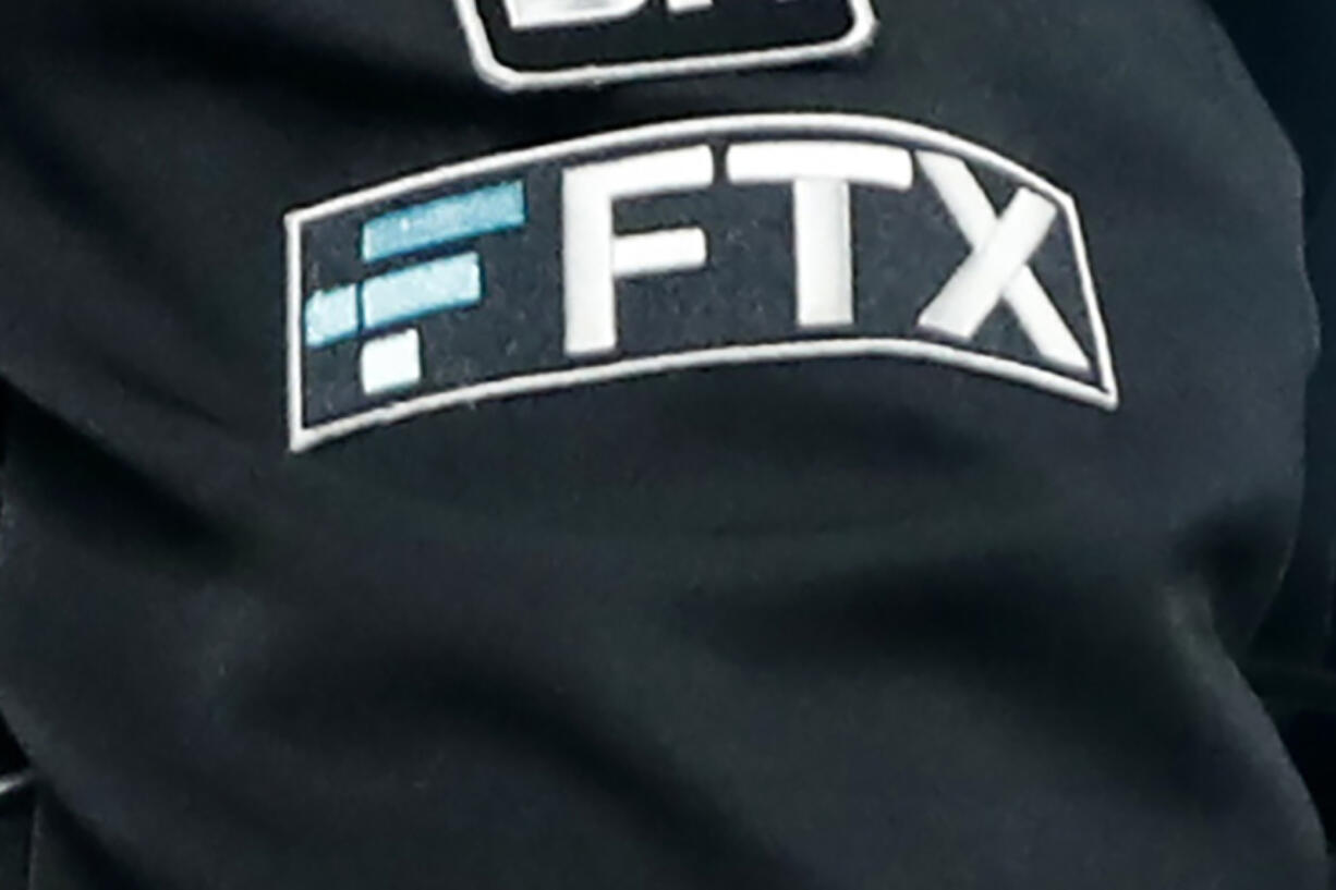 FILE - The FTX logo appears on home plate umpire Jansen Visconti&rsquo;s jacket at a baseball game with the Minnesota Twins on Sept. 27, 2022, in Minneapolis. Failed cryptocurrency exchange FTX says that nearly all of its customers will receive the money back that they are owed, and some will get more than that, according to its reorganization plan. FTX said in a court filing Tuesday, May 7, 2024 that it owes about $11.2 billion to its creditors.