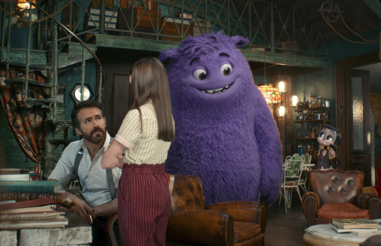 This image released by Paramount Pictures shows Ryan Reynolds, from left, Cailey Fleming, the character Blue, voiced by Steve Carell, and the Blossom, voiced by Phoebe Waller-Bridge, in a scene from &ldquo;IF.&rdquo; (Paramount Pictures via AP)
