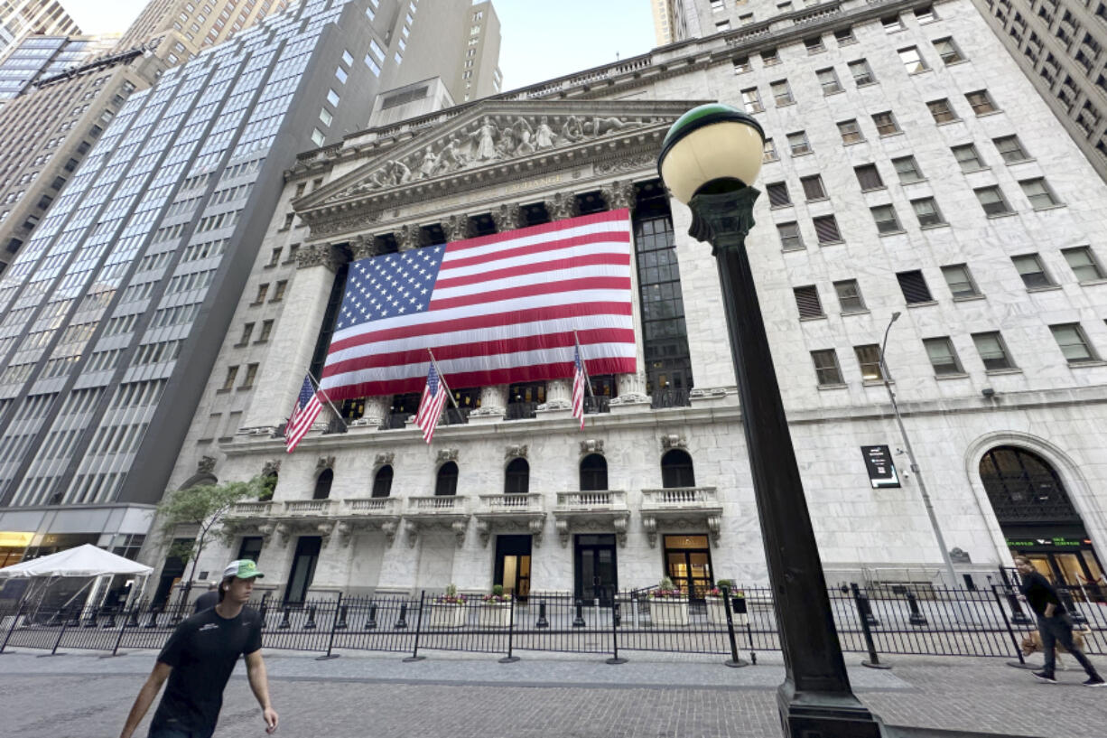 People pass the New York Stock Exchange on Tuesday, May 28, 2024, in New York. Shares are mostly lower in Europe and Asia after U.S. markets were closed for the Memorial Day holiday.