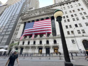 People pass the New York Stock Exchange on Tuesday, May 28, 2024, in New York. Shares are mostly lower in Europe and Asia after U.S. markets were closed for the Memorial Day holiday.