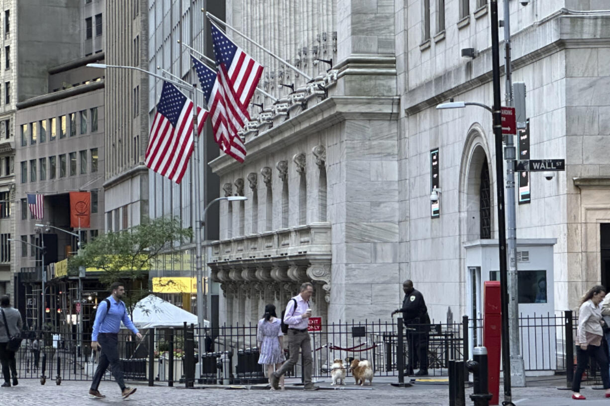 People pass the New York Stock Exchange on Wednesday, May 29, 2024, in New York. Wall Street was poised to open with losses as some major dealmaking and a handful of earnings reports fill the news void until Friday&rsquo;s latest inflation report.