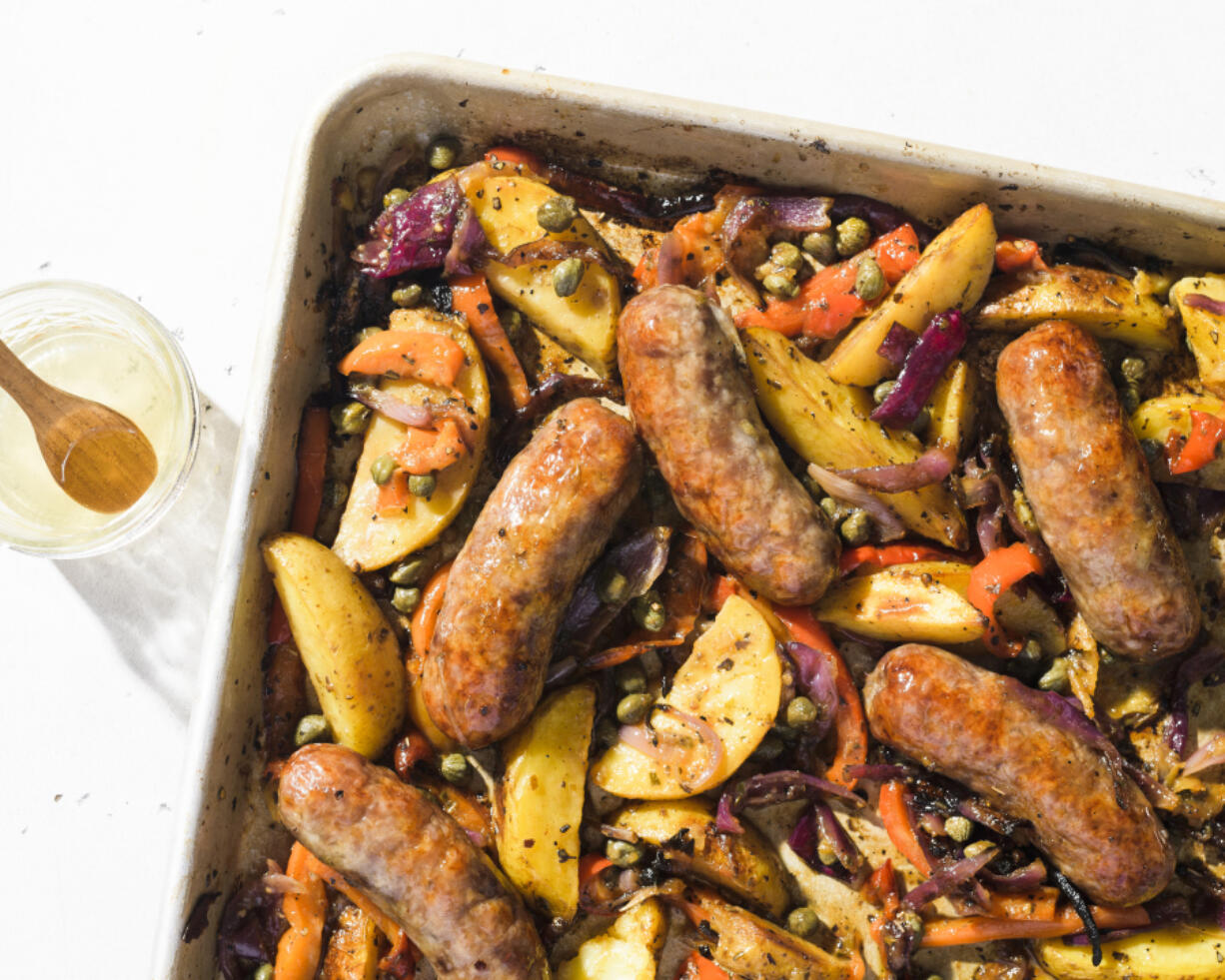 This image released by Milk Street shows a recipe for sausage and potato traybake.