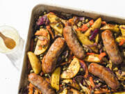 This image released by Milk Street shows a recipe for sausage and potato traybake.