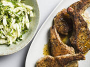 This image released by Milk Street shows a recipe for seared pork chops with fennel and herb salad.