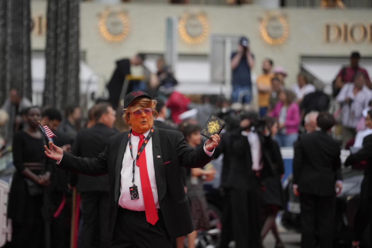 A person dressed as Donald Trump poses for photographers upon arrival at the premiere of the film &lsquo;The Apprentice&rsquo; at the 77th international film festival, Cannes, southern France, Monday, May 20, 2024.
