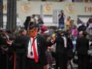 A person dressed as Donald Trump poses for photographers upon arrival at the premiere of the film &lsquo;The Apprentice&rsquo; at the 77th international film festival, Cannes, southern France, Monday, May 20, 2024.