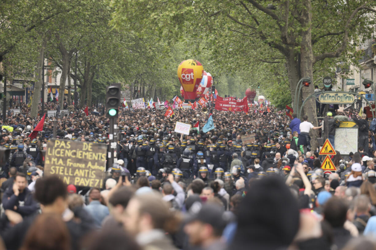 Thousands of people march during the May Day demonstration, Wednesday, May 1, 2024 in Paris. Thousands of protesters marched through the French capital, seeking better pay and working conditions. Pro-Palestinian groups and anti-Olympics activists joined the rally in Paris which will host the Summer Games in less than three months.