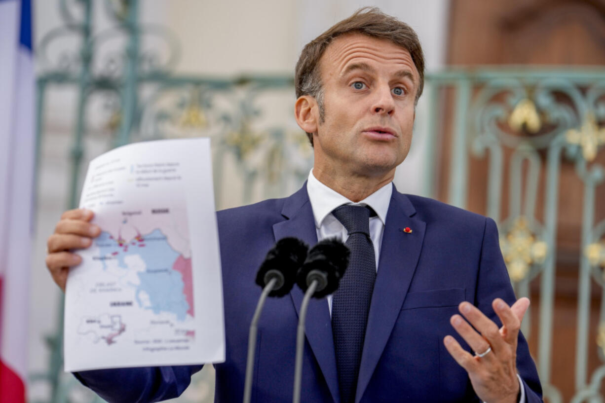French President Emmanuel Macron shows a map during a press conference at the German government guest house in Meseberg, north of Berlin, Germany, Tuesday, May 28, 2024.