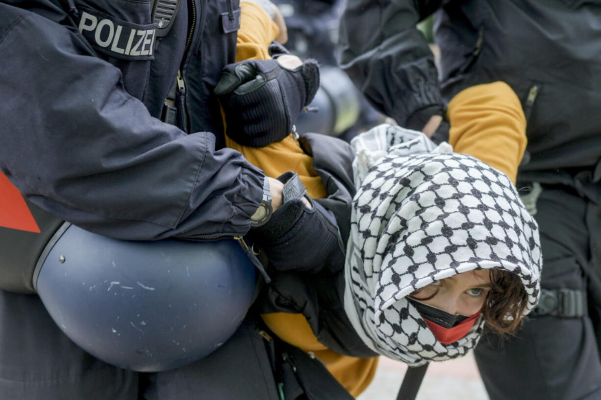 A woman is carried away by police officers during a pro-Palestinians demonstration by the group &ldquo;Student Coalition Berlin&rdquo; in the theater courtyard of the &lsquo;Freie Universit&auml;t Berlin&rsquo; university in Berlin, Germany, Tuesday, May 7, 2024. Pro-Palestinian activists occupied a courtyard of the Free University in Berlin on Tuesday.