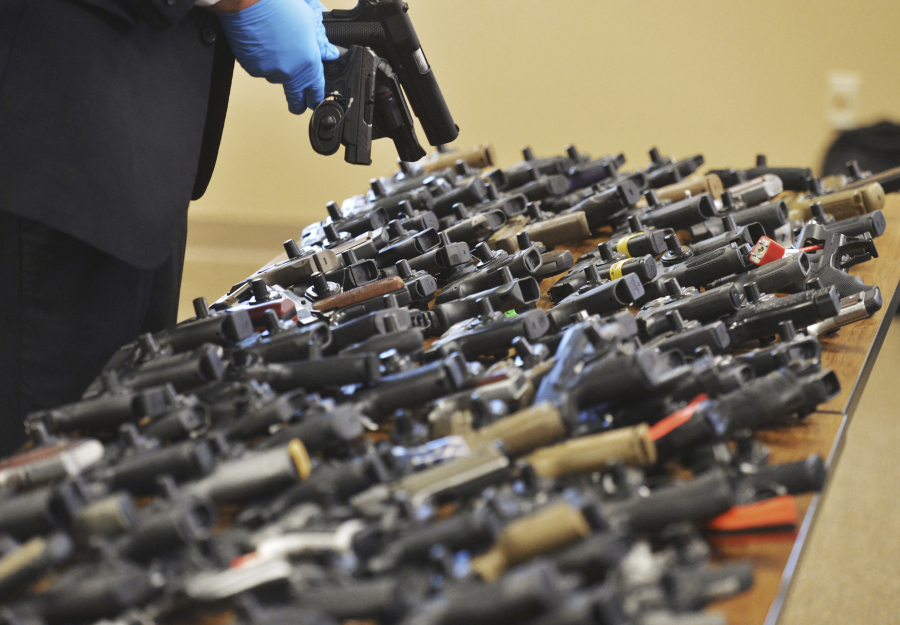 FILE - Dozens of recovered stolen handguns are displayed during a press conference, Nov. 21, 2023, in Benton Township, Mich. Two men, who are brothers, are accused of targeting a Dunham&rsquo;s near Benton Harbor. The rate of guns stolen from cars in the U.S. has tripled over the last decade, making them the largest source of stolen guns in the country, a new analysis of FBI data by the gun-safety group Everytown found.