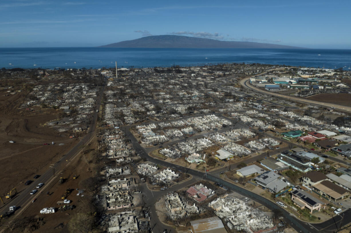 FILE - A general view shows the aftermath of a wildfire in Lahaina, Hawaii, Thursday, Aug. 17, 2023. Maui County is suing major cellular carriers for failing to properly inform police of widespread service outages during the height of last summer&rsquo;s deadly wildfire. (AP Photo/Jae C.