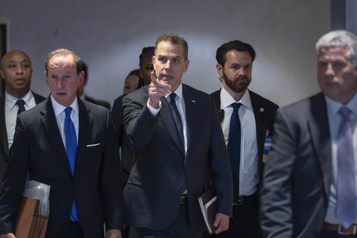 FILE - Hunter Biden, son of President Joe Biden, with attorney Abbe Lowell, left, leaves after a closed-door deposition on Capitol Hill in Washington, Wednesday, Feb. 28, 2024. Biden&rsquo;s lawyers will press a judge Wednesday, May 22, 2024, to delay his trial in Los Angeles, set to begin next month on charges accusing him of a scheme to avoid paying $1.4 million in taxes. (AP Photo/J.