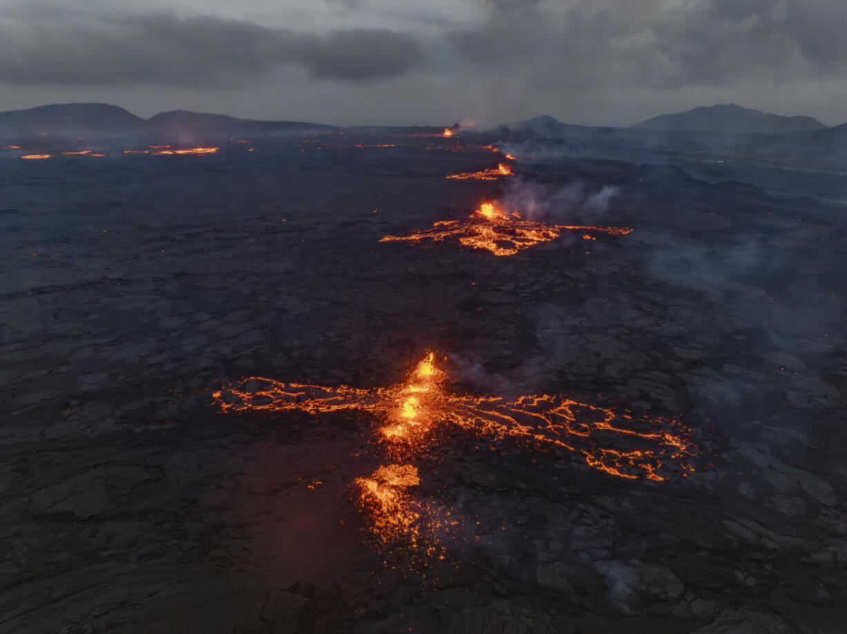 Eruptive fissures spew lava and smoke from a volcano in Grindavik, Iceland, Wednesday, May 29, 2024. A volcano in southwestern Iceland erupted Wednesday for the fifth time since December, spewing red lava that once again threatened the coastal town of Grindavik and led to the evacuation of the popular Blue Lagoon geothermal spa.