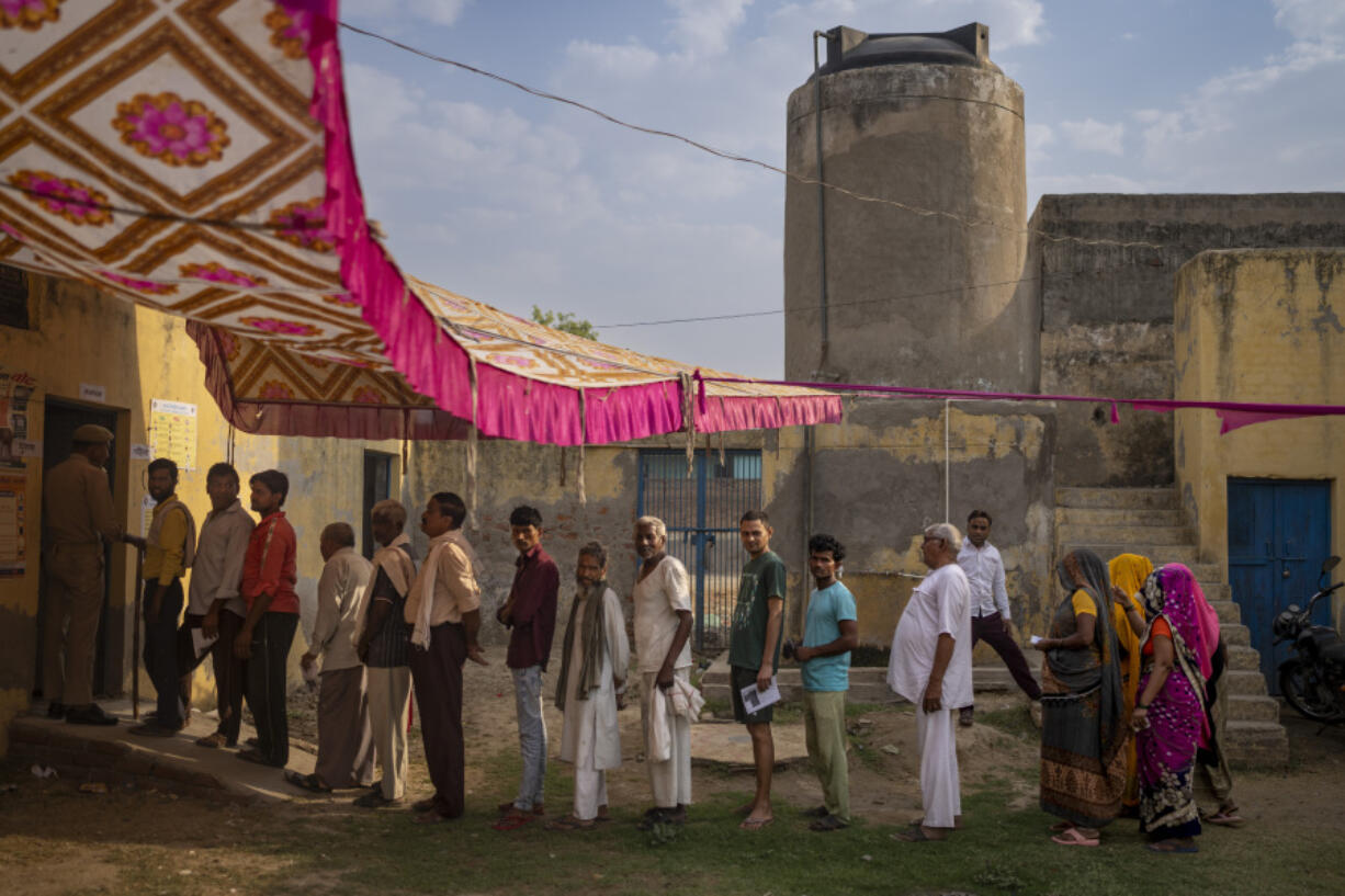 People stand in queue to vote during the third round of voting in the six-week-long general election in Agra, Uttar Pradesh, India, Tuesday, May 7, 2024.