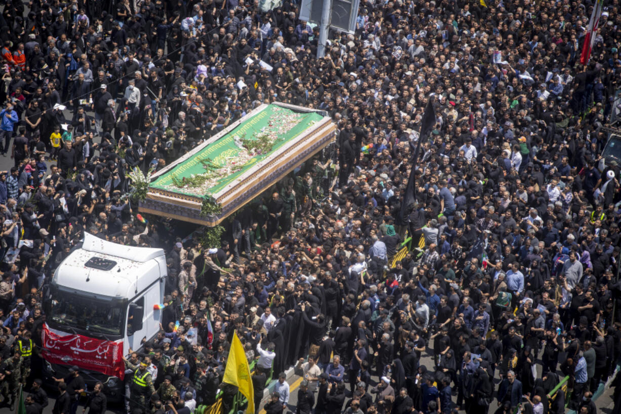 Iranians follow a truck carrying coffins of the late President Ebrahim Raisi and his companions who were killed in a helicopter crash on Sunday in a mountainous region of the country&rsquo;s northwest, during a funeral ceremony for them in Tehran, Iran, Wednesday, May 22, 2024. Iran&rsquo;s supreme leader presided over the funeral Wednesday for the country&rsquo;s late president, foreign minister and others killed in the helicopter crash, as tens of thousands later followed a procession of their caskets through the capital, Tehran.