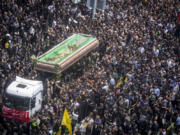 Iranians follow a truck carrying coffins of the late President Ebrahim Raisi and his companions who were killed in a helicopter crash on Sunday in a mountainous region of the country&rsquo;s northwest, during a funeral ceremony for them in Tehran, Iran, Wednesday, May 22, 2024. Iran&rsquo;s supreme leader presided over the funeral Wednesday for the country&rsquo;s late president, foreign minister and others killed in the helicopter crash, as tens of thousands later followed a procession of their caskets through the capital, Tehran.