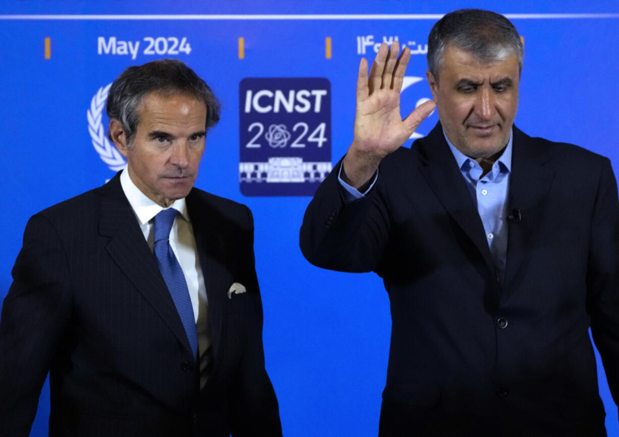 FILE - Head of Iran&rsquo;s atomic energy department Mohammad Eslami waves to media at the conclusion of his joint press conference with International Atomic Energy Organization, IAEA, Director General Rafael Mariano Grossi, left, after their meeting in the central city of Isfahan, Iran, on May 7, 2024. While Iran&rsquo;s nuclear program stands at the precipice of tipping over into enriching uranium at weapons-grade levels, Tehran has held quiet, indirect talks with the United States and invited the head of the United Nations&rsquo; atomic watchdog into the country for negotiations.