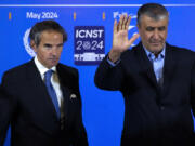 FILE - Head of Iran&rsquo;s atomic energy department Mohammad Eslami waves to media at the conclusion of his joint press conference with International Atomic Energy Organization, IAEA, Director General Rafael Mariano Grossi, left, after their meeting in the central city of Isfahan, Iran, on May 7, 2024. While Iran&rsquo;s nuclear program stands at the precipice of tipping over into enriching uranium at weapons-grade levels, Tehran has held quiet, indirect talks with the United States and invited the head of the United Nations&rsquo; atomic watchdog into the country for negotiations.