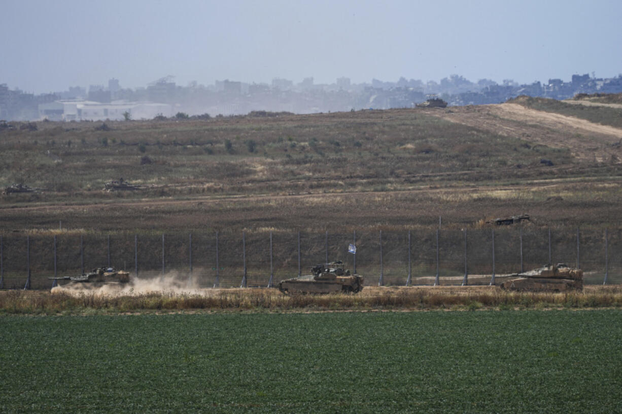 Israeli tanks move near the Israeli-Gaza border, as seen from southern Israel, Sunday, May 12, 2024.