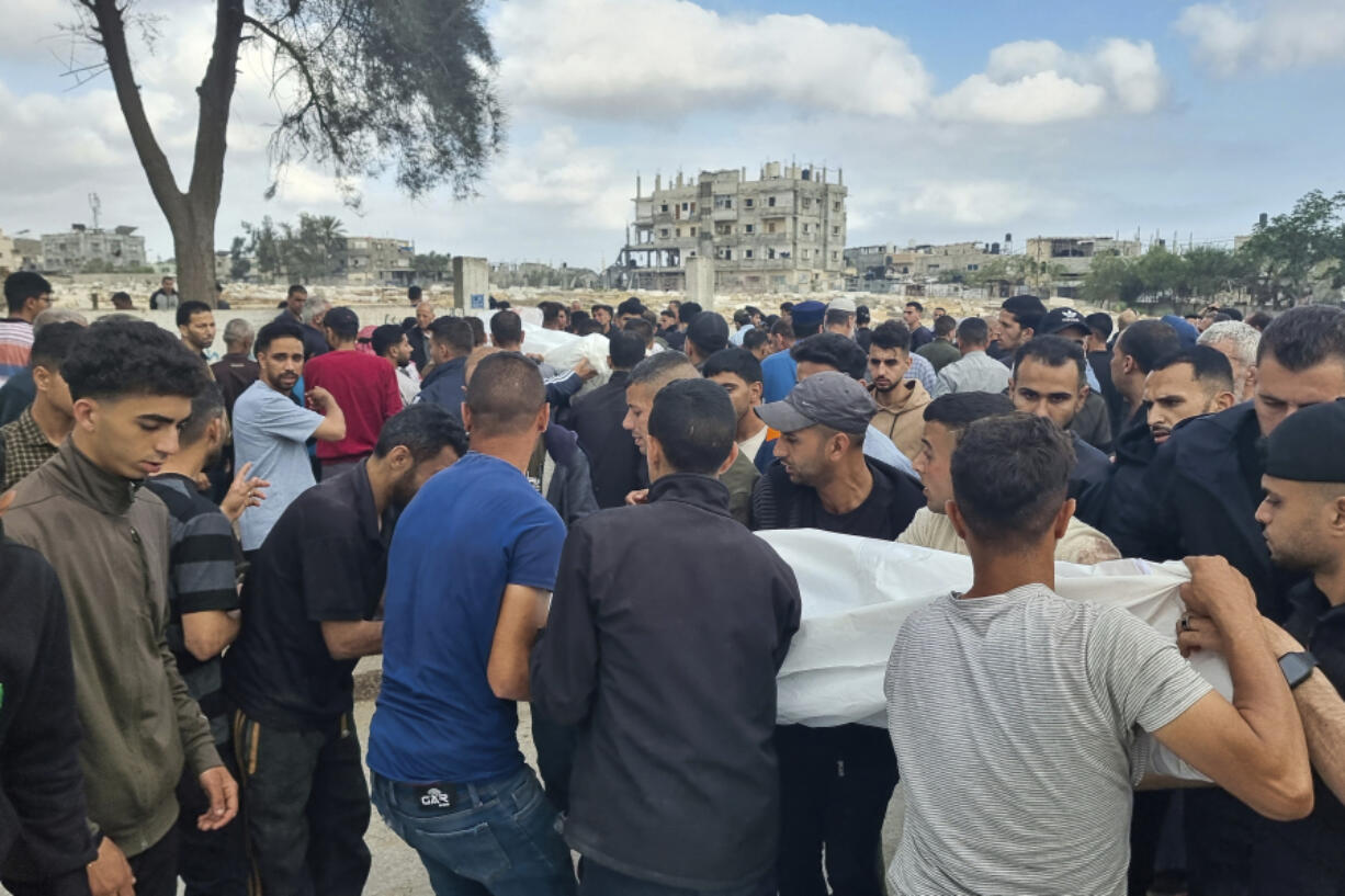 Mourners carry the bodies of members of the Abu Taha family who were killed in an Israeli airstrike, during their funeral at Al-Salam cemetery, east of Rafah, Gaza Strip. Monday, April 29, 2024.