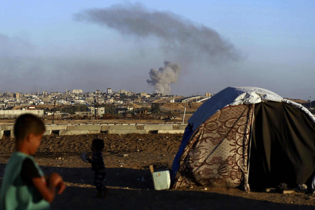 Smoke rises following an Israeli airstrike on buildings near the separating wall between Egypt and Rafah, southern Gaza Strip, Tuesday, May 7, 2024.