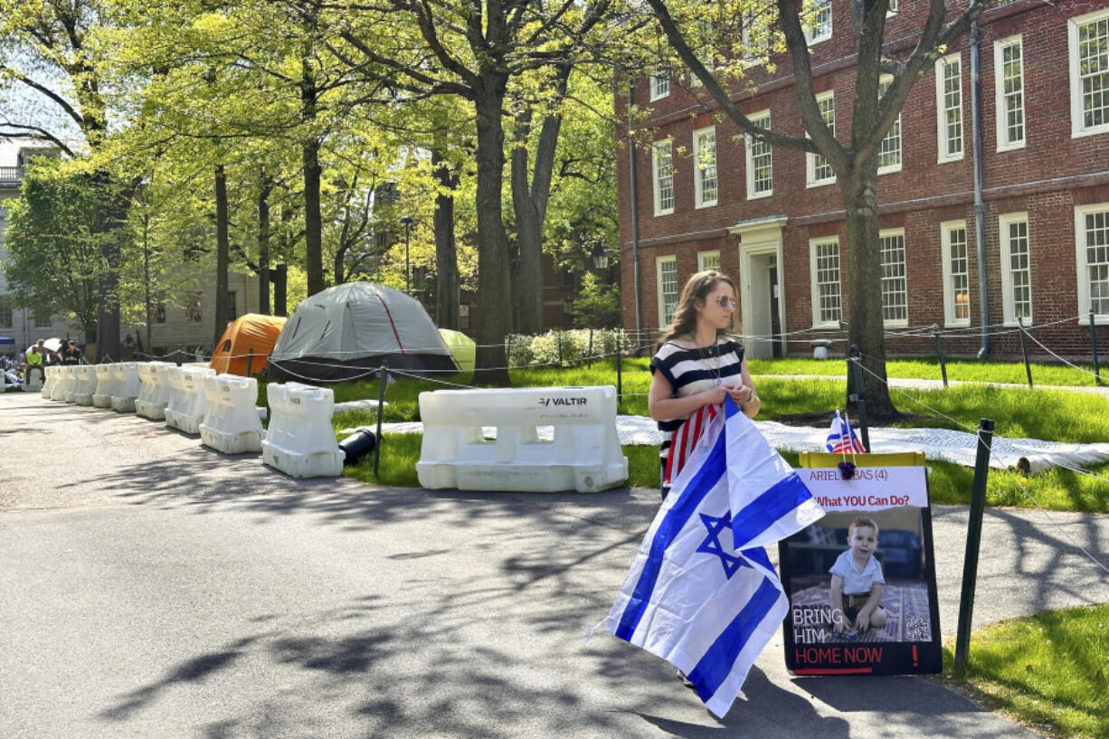 Rotem Spiegler, an alumni of Harvard University, stands near an encampment set up at the university to protest the war in Gaza, Tuesday, May 14, 2024, in Cambridge, Mass. The encampment was being voluntarily removed early Tuesday.