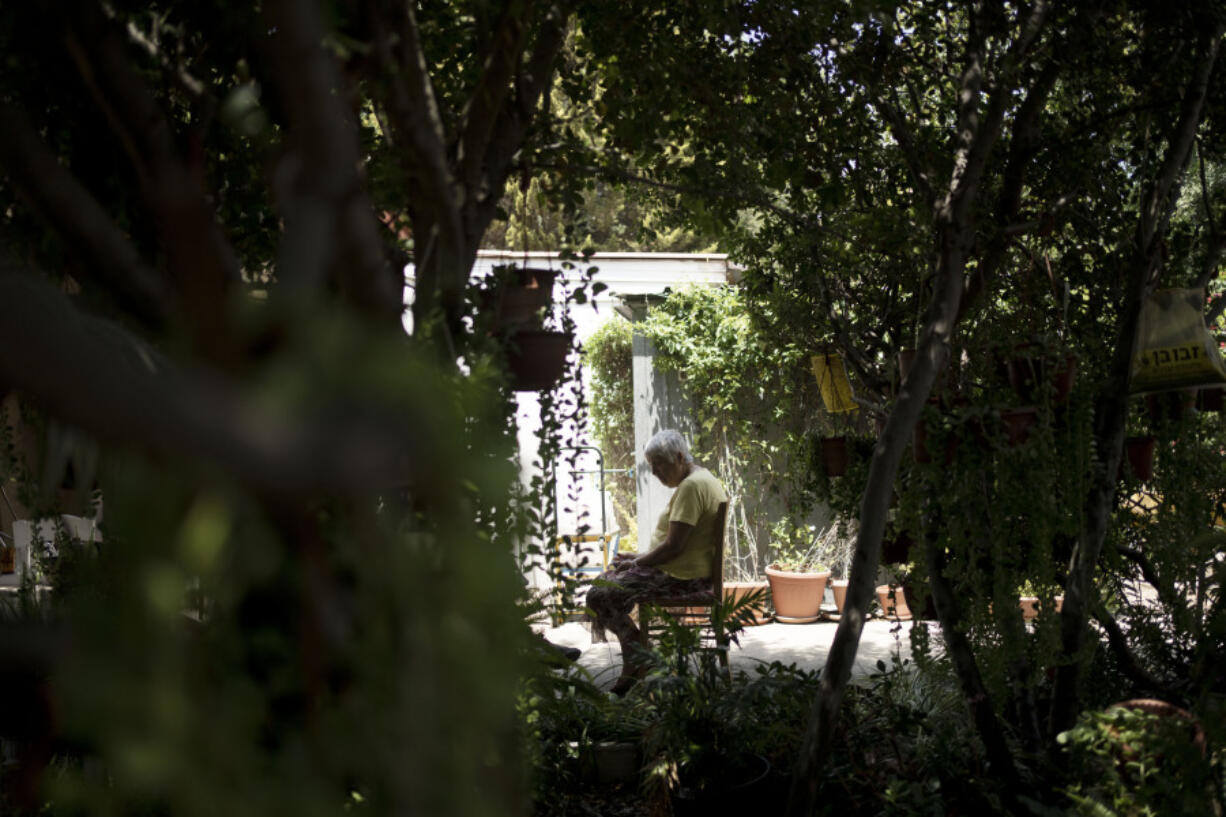 Judith Tzamir, a Holocaust survivor from Germany, speaks to a journalist in her family home in Kibbutz Meflasim, southern Israel, Friday, May 3, 2024. On Monday, Tzamir will join 55 other Holocaust survivors from Israel and around the world for a memorial march in Poland, called March of the Living.