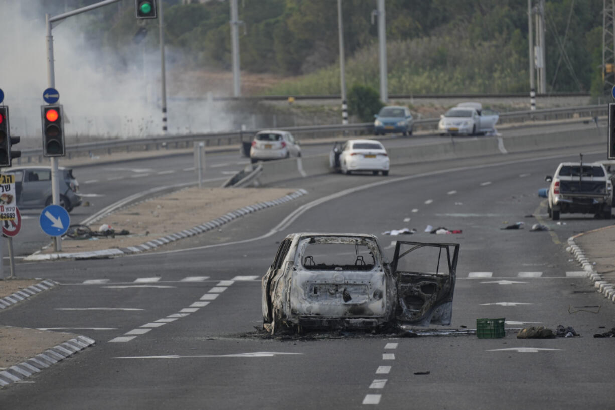 FILE - A car destroyed in an attack by Palestinian militants is seen in Sderot, Israel, on Saturday, Oct. 7, 2023.