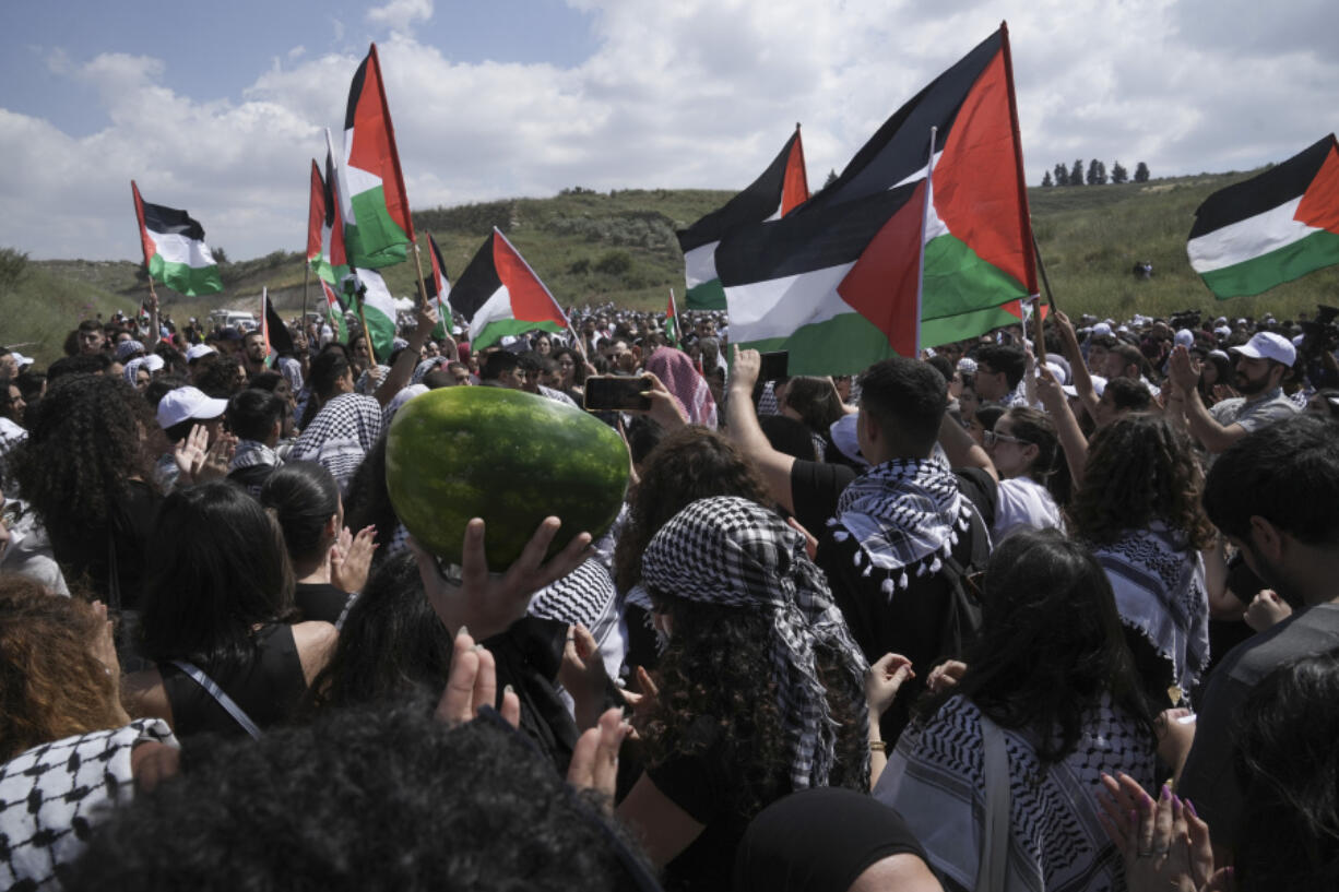 People take part in a march in support of the Palestinian people ahead the Nakba day at the Al Kasayir village, in Haifa, Tuesday, May 14, 2024. Palestinians on Wednesday, May 15, 2024, will mark the 76th year of their mass expulsion from what is now Israel. They refer to it as the Nakba, Arabic for catastrophe.