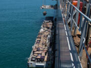 Humanitarian aid is lifted by a crane operated by soldiers assigned to the 7th Transportation Brigade (Expeditionary) from a Navy causeway at the Port of Ashdod, Israel, May 14, 2024. These soldiers are supporting the construction of the Joint Logistics Over-the-Shore system off the shore of Gaza.  (Staff Sgt. Malcolm Cohens-Ashley/U.S.