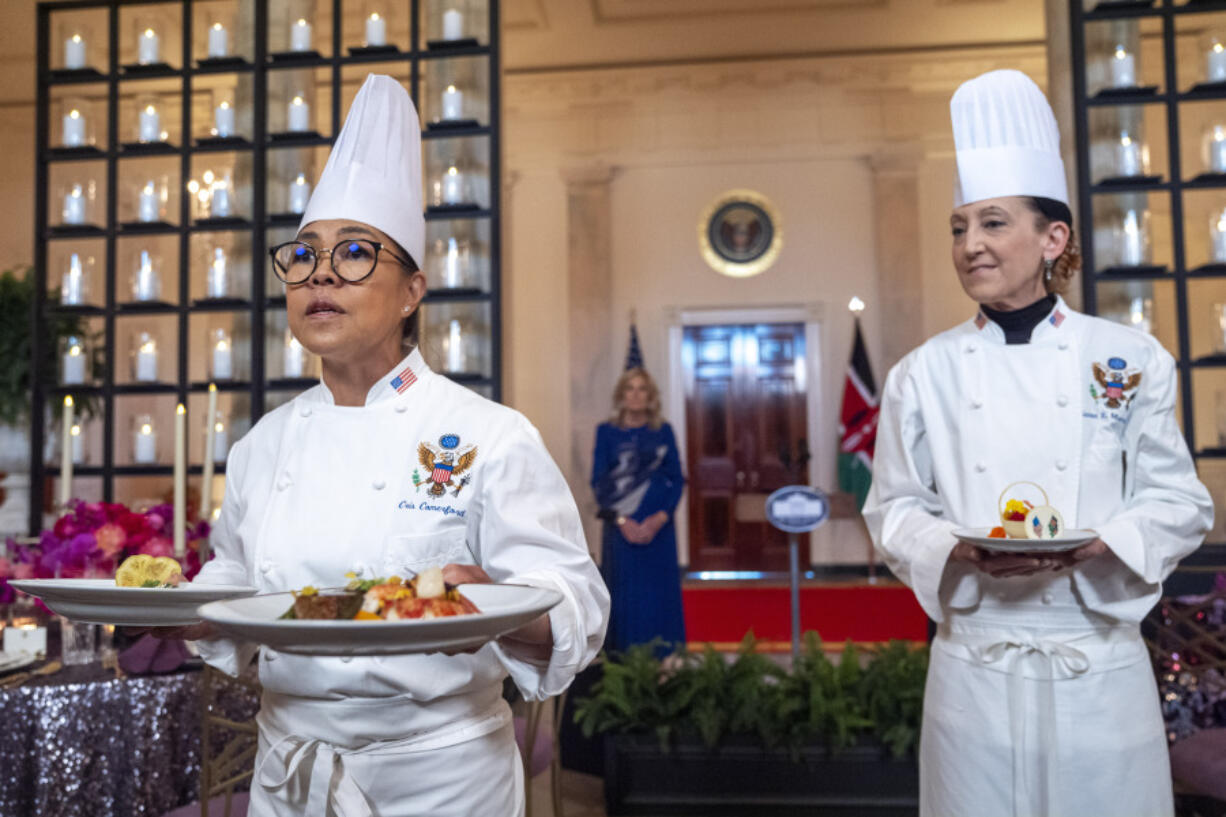 White House Executive Chef Cris Comerford, left, holds the first and main courses, as White House Executive Pastry Chef Susie Morrison holds the dessert  course during a media preview ahead of Thursday evening&rsquo;s state dinner with Kenya&rsquo;s President William Ruto, at the White House in Washington.
