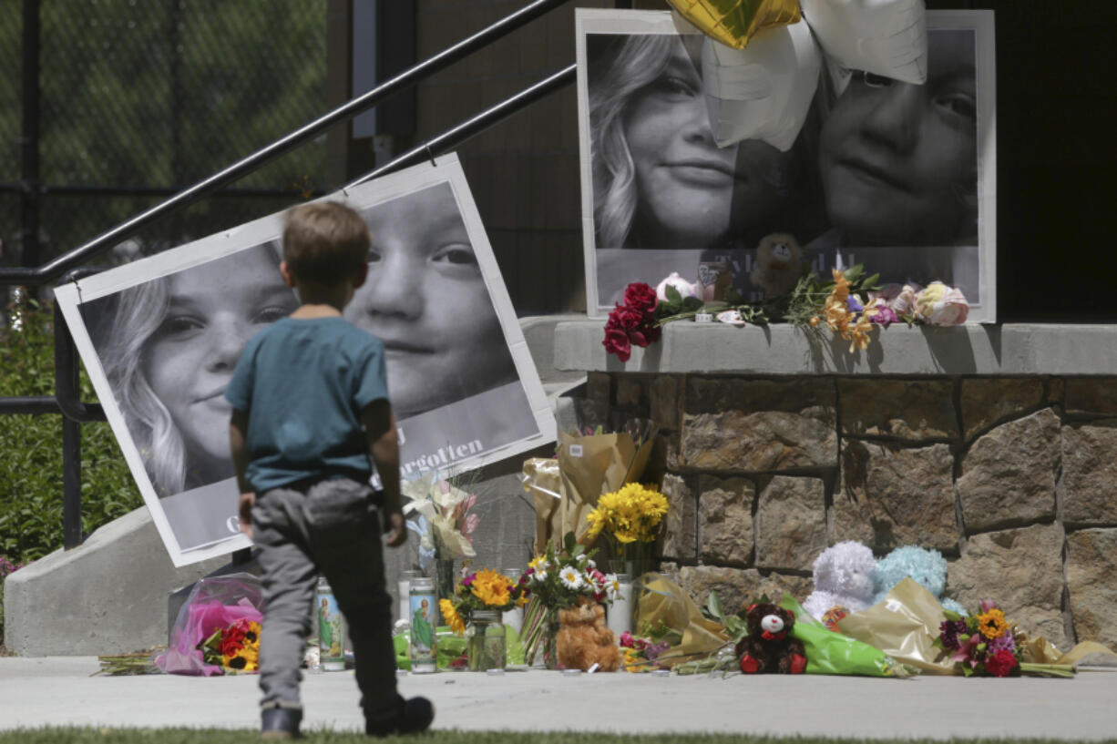 A boy looks at a memorial for Tylee Ryan and Joshua &ldquo;JJ&rdquo; Vallow in Rexburg, Idaho, on June 11, 2020. A judge is considering what effect a paperwork snafu should have on one of the three murder charges against Chad Daybell, an Idaho man accused of killing his wife and his new girlfriend's two children.