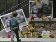 A boy looks at a memorial for Tylee Ryan and Joshua &ldquo;JJ&rdquo; Vallow in Rexburg, Idaho, on June 11, 2020. A judge is considering what effect a paperwork snafu should have on one of the three murder charges against Chad Daybell, an Idaho man accused of killing his wife and his new girlfriend's two children.