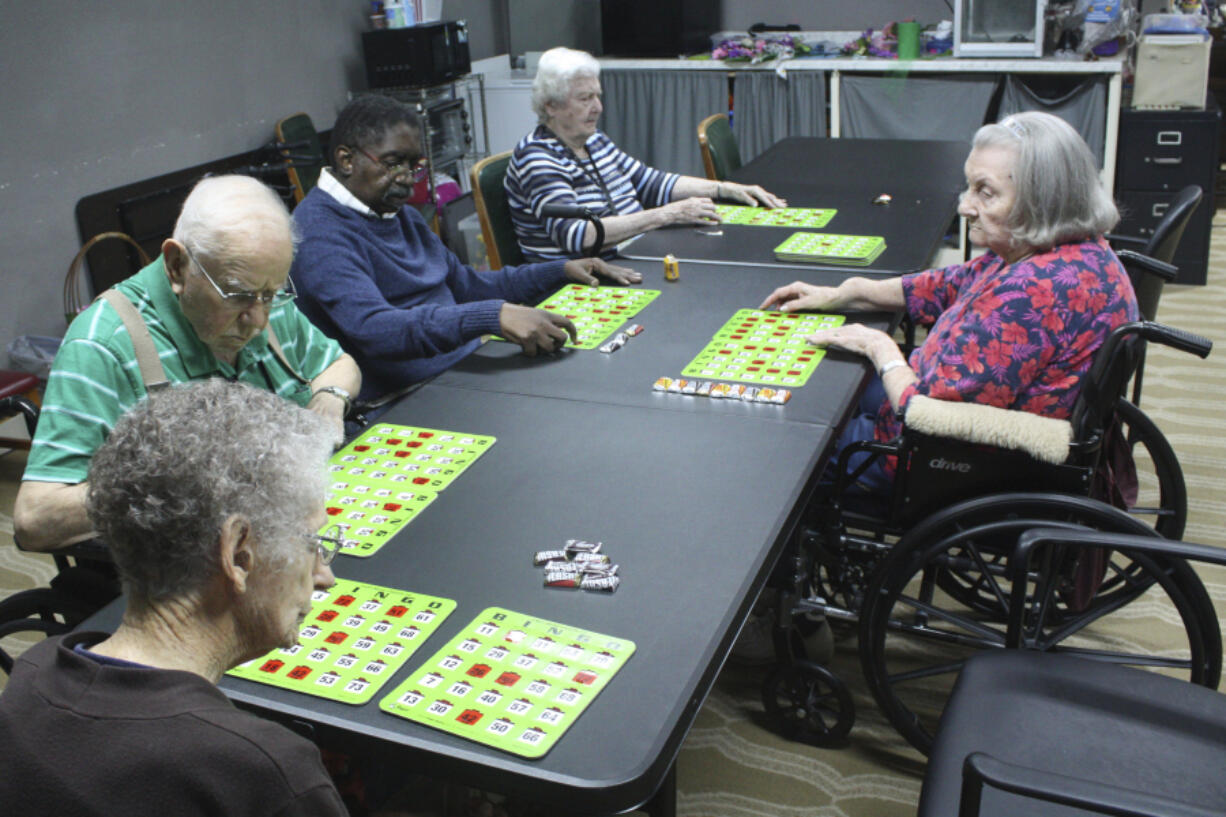 Eberline Nugent, left, Johnny Griffin, Jay Cossey, Carrie Dickson and Joyce Schiessl play bingo during activity time at The Retreat at Kenwood assisted living facility in Texarkana, Texas on Friday, May 17, 2024. Cossey&rsquo;s church community urged the 70-year-old to move in, though his family in Alabama has pushed for him to come live with them.