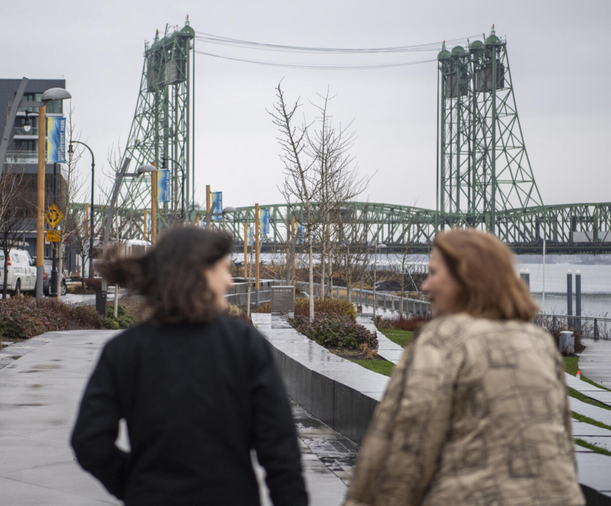 The Interstate 5 Bridge rises above the Columbia River as Rep. Marie Gluesenkamp Perez, D-Skamania, left, and Vancouver Mayor Anne McEnerny-Ogle talk Jan. 13, 2023, during a tour of key infrastructure projects in Perez&rsquo;s district.