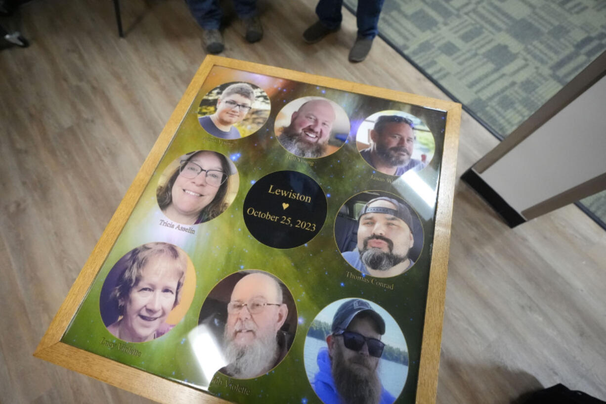 The eight people who were killed last October while bowling at Just In Time Recreation are memorialized on a table top at the bowling alley, Wednesday, May 1, 2024, in Lewiston, Maine. (AP Photo/Robert F.