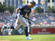 Seattle Mariners Julio Rodriguez runs to first on an RBI single during the eighth inning of a baseball game against the Washington Nationals, Sunday, May 26, 2024, in Washington.