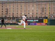 Baltimore Orioles&#039; Gunnar Henderson, center, runs the bases after hitting a home run against the Seattle Mariners during the first inning of a baseball game at Oriole Park at Camden Yards, Sunday, May 19, 2024, in Baltimore.