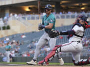 Seattle Mariners&#039; Josh Rojas reacts after striking out during the first inning of a baseball game against the Minnesota Twins, Wednesday, May 8, 2024, in Minneapolis.