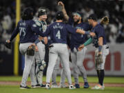 Seattle Mariners&#039; J.P. Crawford (3), and catcher Cal Raleigh celebrates with teammates after a baseball game against the New York Yankees, Monday, May 20, 2024, in New York. The Mariners won 5-4.