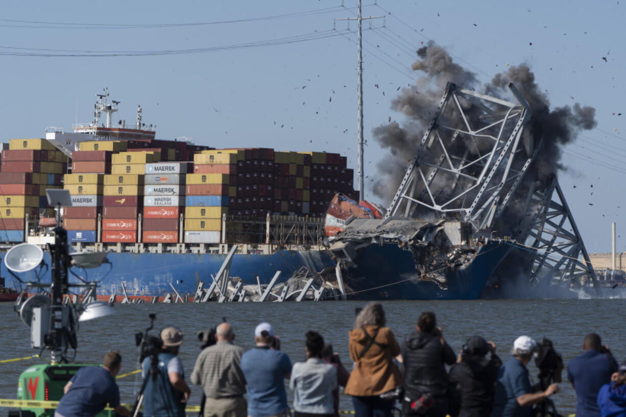 Explosive charges are detonated to bring down sections of the collapsed Francis Scott Key Bridge resting on the container ship Dali on Monday, in Baltimore.