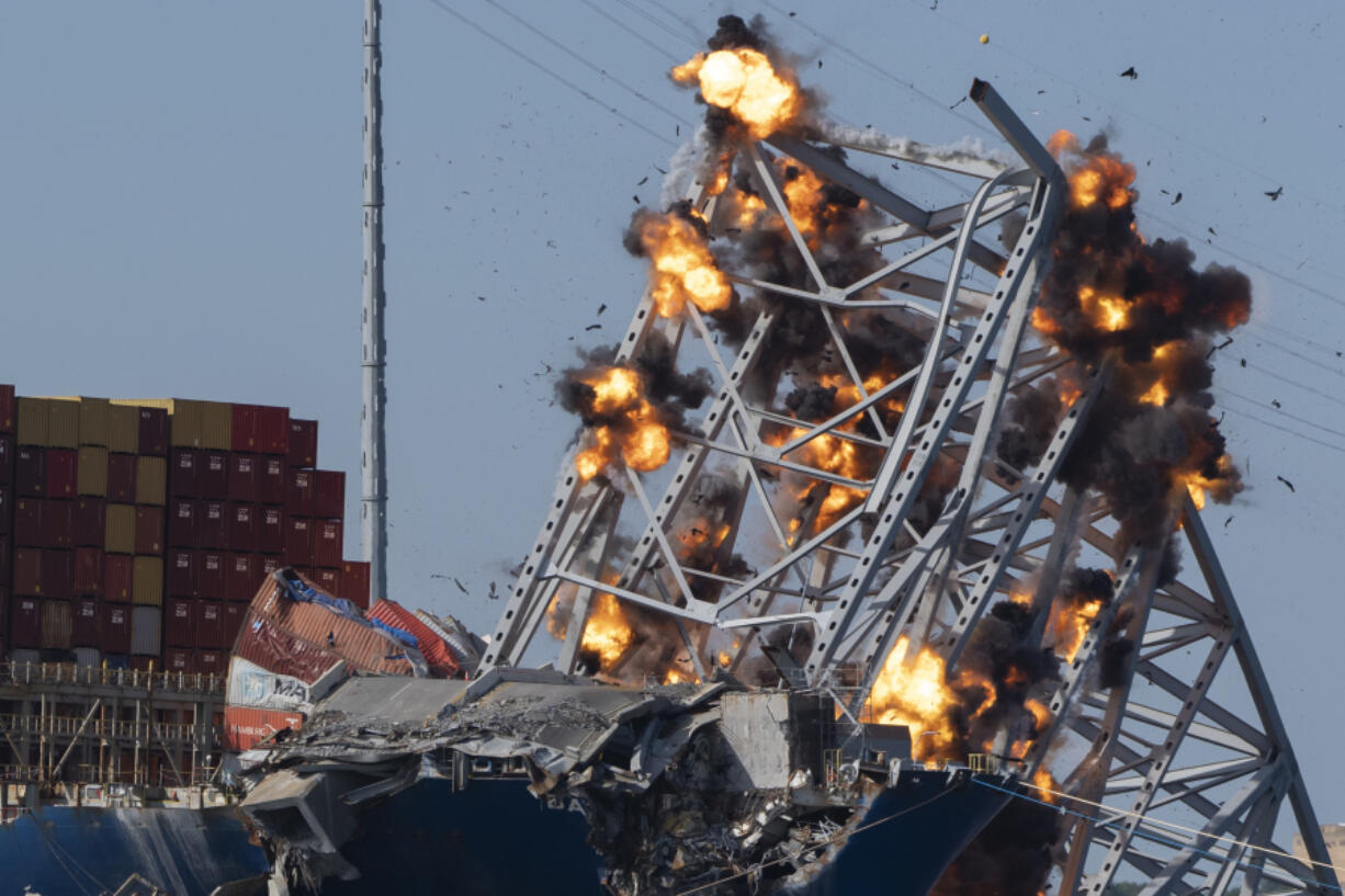 Explosive charges are detonated to bring down sections of the collapsed Francis Scott Key Bridge resting on the container ship Dali on Monday, May 13, 2024, in Baltimore.