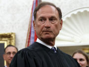 FILE - Supreme Court Justice Samuel Alito pauses after swearing in Mark Esper as Secretary of Defense during a ceremony with President Donald Trump in the Oval Office at the White House in Washington, July 23, 2019. Nine days after The New York Times reported about the political symbolism of an upside-down American flag that flew at U.S. Supreme Court Justice Samuel Alito&rsquo;s home, the Washington Post acknowledged May 25, 2024, that it had the same story more than three years ago and decided not to publish it.