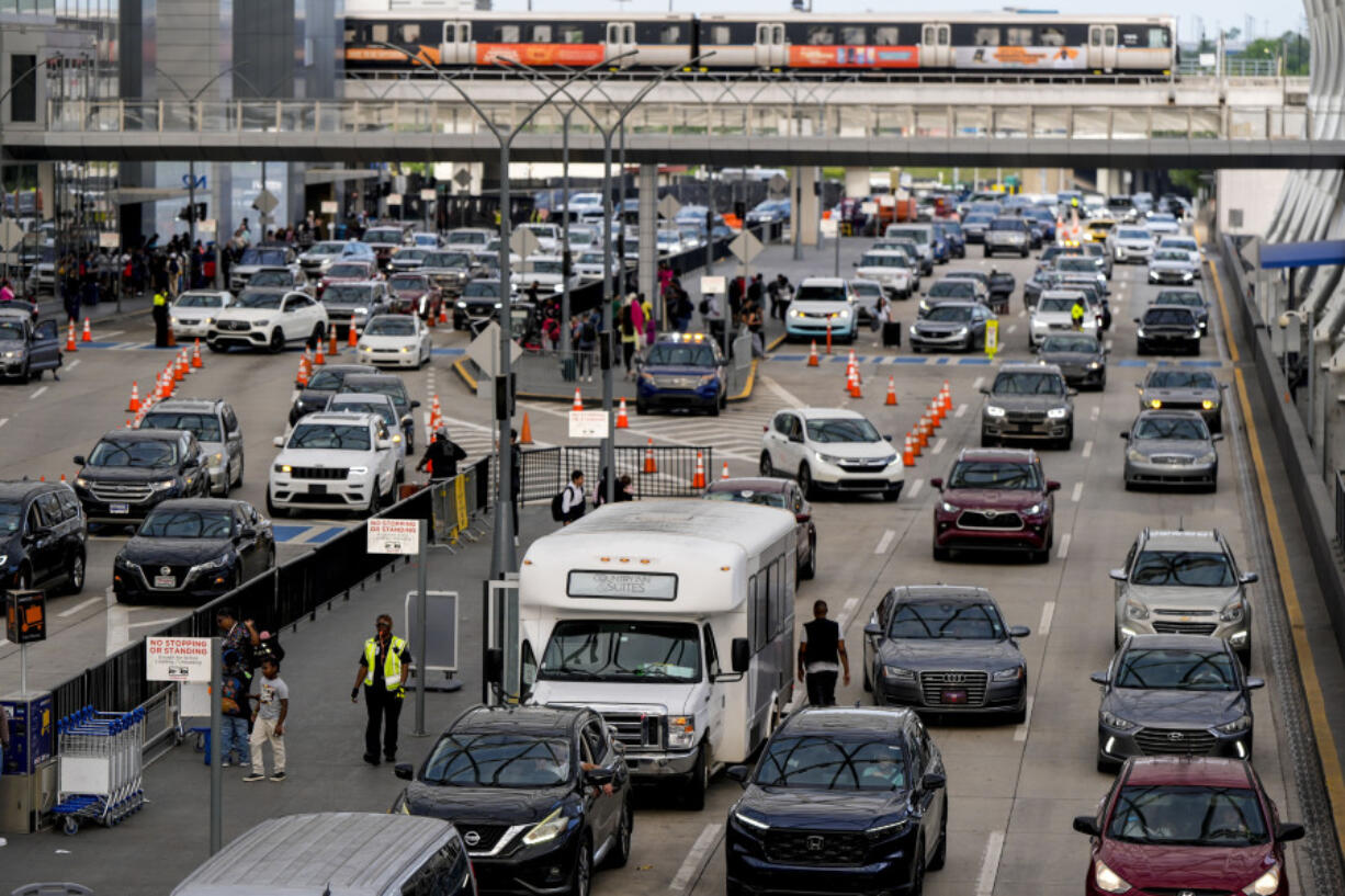 Cars drive through Hartsfield-Jackson Atlanta International Airport ahead of Memorial Day, Friday, May 24, 2024, in Atlanta.(AP Photo/Mike Stewart)