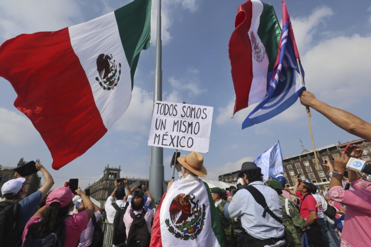 A person holds a sign that reads &ldquo;we are all the same Mexico&rdquo; at an opposition rally called to encourage voting ahead of the June 2 presidential elections, in the Zocalo, Mexico City&rsquo;s main square, Sunday, May 19, 2024.