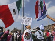 A person holds a sign that reads &ldquo;we are all the same Mexico&rdquo; at an opposition rally called to encourage voting ahead of the June 2 presidential elections, in the Zocalo, Mexico City&rsquo;s main square, Sunday, May 19, 2024.