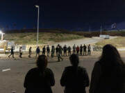 Migrants are lined up along the border walls separating Tijuana, Mexico, and San Diego, to apply for asylum with U.S authorities Tuesday, May 7, 2024, in San Diego. San Diego became the busiest corridor for illegal crossings in April, according to U.S. figures, the fifth region to hold that title in two years in a sign of how quickly migration routes are changing.