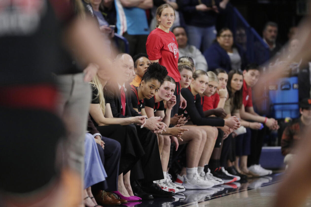 FILE - Players and staff on the Utah bench react toward the end of a second-round college basketball game against Gonzaga in the NCAA Tournament in Spokane, Wash., Monday, March 25, 2024. A northern Idaho prosecutor won&rsquo;t bring hate crime charges against an 18-year-old accused of shouting a racial slur at members of the Utah women&rsquo;s basketball team while the team was in Idaho to attend the NCAA Tournament.