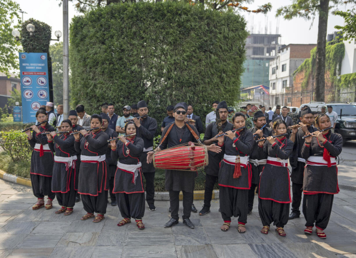 Artistes play traditional music during the first day of Nepal Investment Summit in Kathmandu, Nepal, Sunday, April 28, 2024. Nepal is hosting this summit hoping to attract foreign investments in hydropower projects and tourism.